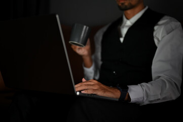 Close-up. A handsome smart male CEO or businessman working on his task on laptop.