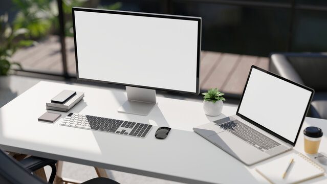 Modern office workplace with Pc desktop computer and laptop white screen mockup