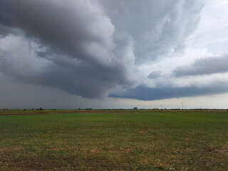 Storm Clouds and early funnel cloud over and Agricultural Field in rural Oklahoma