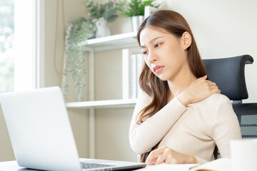 Body muscles stiff problem, ache asian young woman, girl pain neck while sitting work on chair at home, holding massaging rubbing, hurt or sore, Healthcare people, office syndrome .