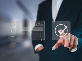 Businessman hand point check mark on virtual screen for quality control QC certification assures that the company product satisfies specifications.