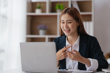 Young business women working and greeting on video conference with happy and smile face on office...