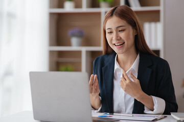 Young business women working and greeting on video conference with happy and smile face on office...
