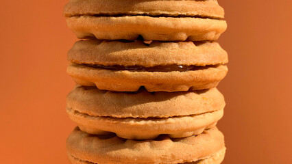 stacks of jam biscuits on the orange studio background