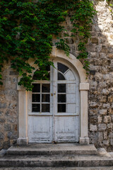 Wooden door in an old stone house