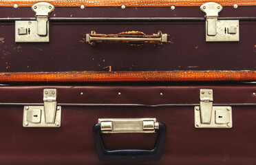 Front view of vintage leather suitcase with metallic locks in retro style