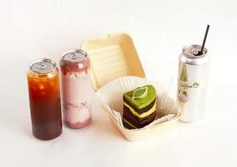 Coffee and Strawberry latte sealed in cans and Green Tea Cake which easy delivery. Isolated on...