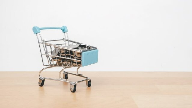 Stop motion animation Money stack on shopping cart, Money saving and economy concept.