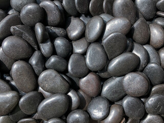 Fototapeta na wymiar Black pebbles on the beach