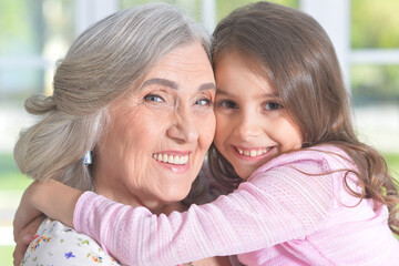 grandmother and granddaughter posing beautifully at home