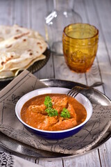 Spicy creamy butter chicken with Indian bread