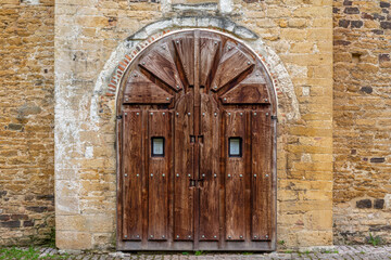Fototapeta na wymiar Wooden entrance gate to the Church and facade of San Miguel de Lillo, Oviedo, Asturias, Spain.