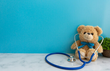 Children doctor concept - Teddy Bear with stethoscope. copy space