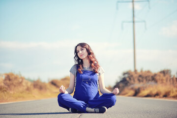 Pregnant woman  on the road yoga