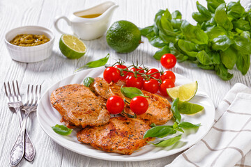 tomato basil pesto fried pork cutlets on plate