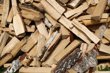 Winter preparation. Stacking Firewood. Pile of firewood loggs. Firewood background.