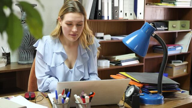 Portrait of female office worker in company at a modern workplace