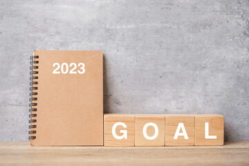 2023 calendar with GOAL block on wood table. Happy New Year, motivation, Resolution, To do list, start, Strategy and Plan concept