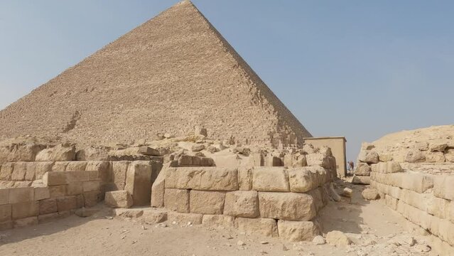 Sand blocks in front of the Pyramid of Khufu, at the Giza pyramid complex, in sunny Egypt, Africa - tilt view