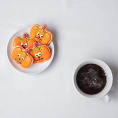 hot coffee cup with funny Halloween Cookies. Happy Halloween day, Trick or Threat, Hello October, fall autumn, Traditional, party and holiday concept