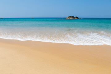 Clean sandy beach with beautiful blue sea and clear sky, tropical beach in south of Thailand, nature background