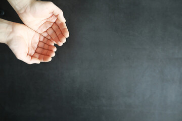 Male hands on a gray background. Finger gestures. Gesticulation with hands.