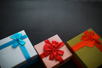 Christmas decoration. Gift boxes on black stone  background. Christmas greeting card concept.