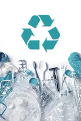 Pile of plastic waste and recycling symbol
