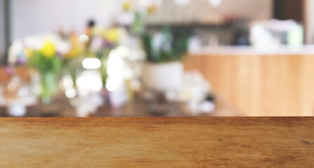 Wood  top table Blur coffee shop or cafe restaurant with abstract bokeh light image background....