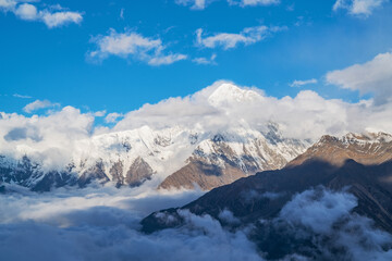 Naklejka na ściany i meble The natural beauty of Gongga snow mountain and blue sky and white clouds in Western Sichuan, China