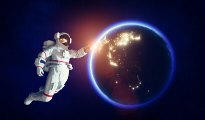 Astronaut spacewalk in space near Earth and pointing his finger