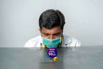 Special offer symbol. young doctor analysing the advertisement 50 percent offer 