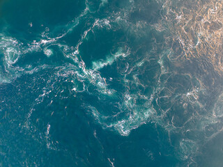 Aerial topdown view of powerful ocean current with sunset color - 514902634