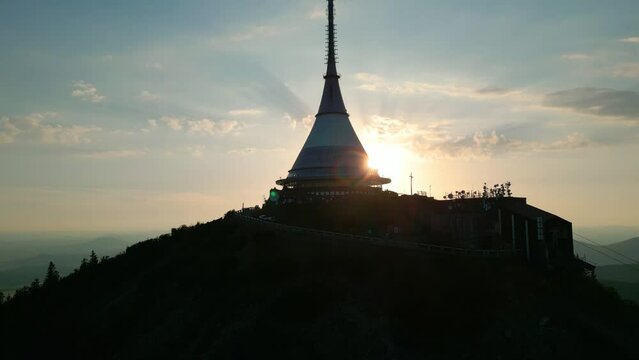Silhouette of Jested Tower, Hotel, Restaurand and TV Tower in Liberec Czech Republic with sun setting in background