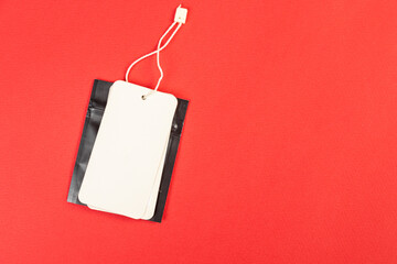 white price tag on a red isolated background, price tag for goods