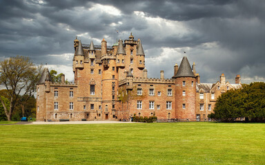 Glamis castle in scotland with dramatic sky