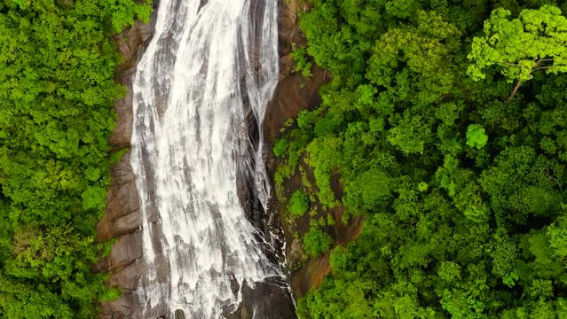 Aerial view of waterfall in the rainforest. Kuda Falls in the tropical mountain jungle. Sri Lanka.