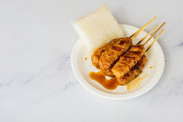 grilled skewered milk pork with white sticky rice - local Thai street food style