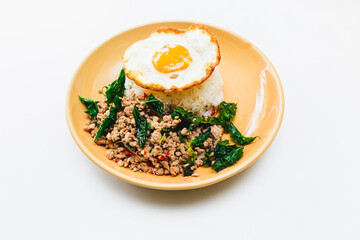Thai Food Stir-Fried Chicken Spicy and Basil served with Rice ,Fried egg  white plate side view isolated on background