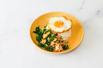 Thai Food Stir-Fried Chicken Spicy and Basil served with Rice ,Fried egg  white plate side view isolated on background
