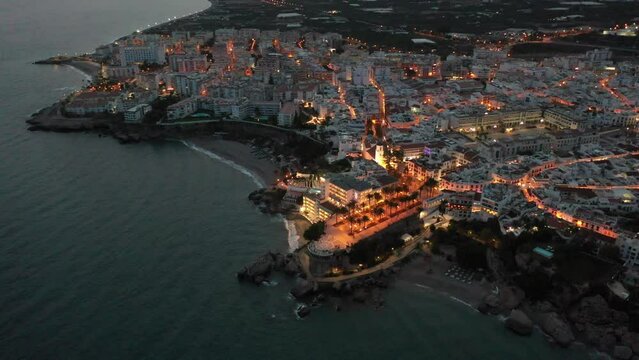 Scenic view from drone of spanish town of Nerja on southern Mediterranean coast at night, Malaga, Spain