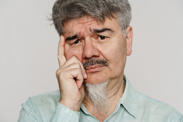Obraz premium Senior sad man with mustache and beard looking at camera