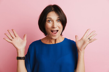Mature woman expressing surprise while gesturing at camera
