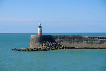 Harbour entrance with lighthouse Newhaven, East Sussex, England on a summer day