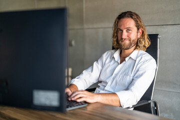 Businessman working on computer at desk in office