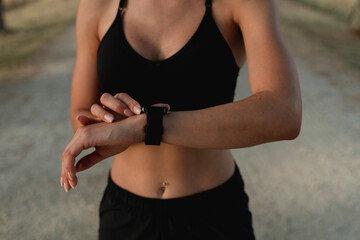 Young woman checking time in smart watch
