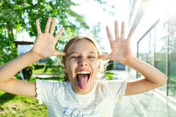 Girl with blond hair sticking out tongue