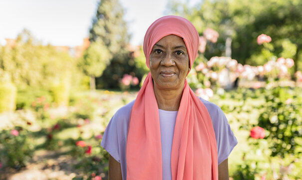 Smiling Senior Woman With Headscarf In Park