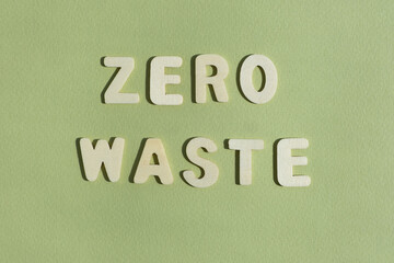 The words ZERO WASTE on a green background. The concept of biophilia and ecology. Top view. Copy...