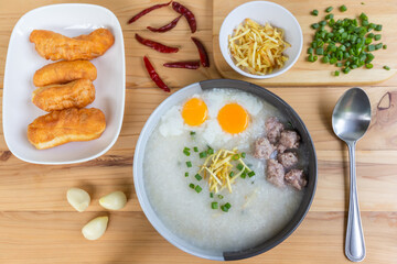 rice porridge or congee with minced pork and soft-boiled eggs